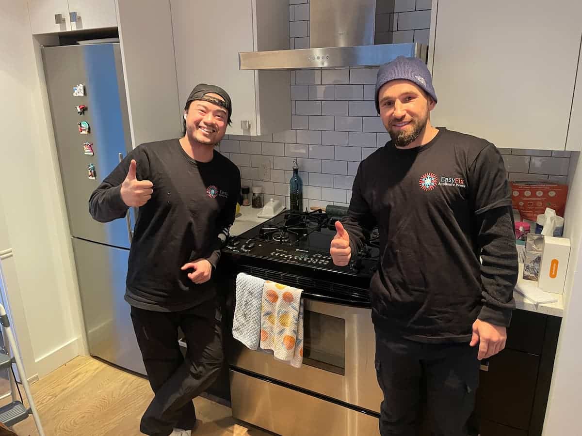 EasyFix technicians completing appliance repair on a gas stove and hood fan in North Vancouver kitchen